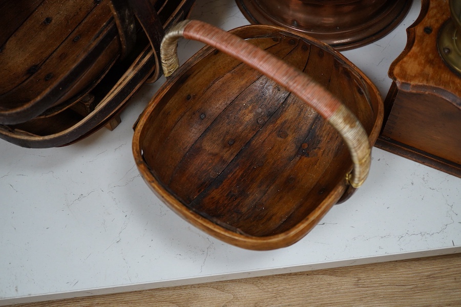 Brass and copper pedestal log-box three Sussex trugs and coffee mill, log box 32cm high